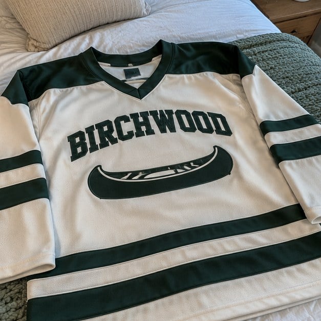 Customer photo of a custom hockey jersey on a bed