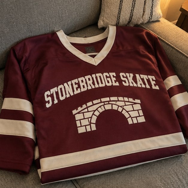 Customer photo of a custom hockey jersey on a couch